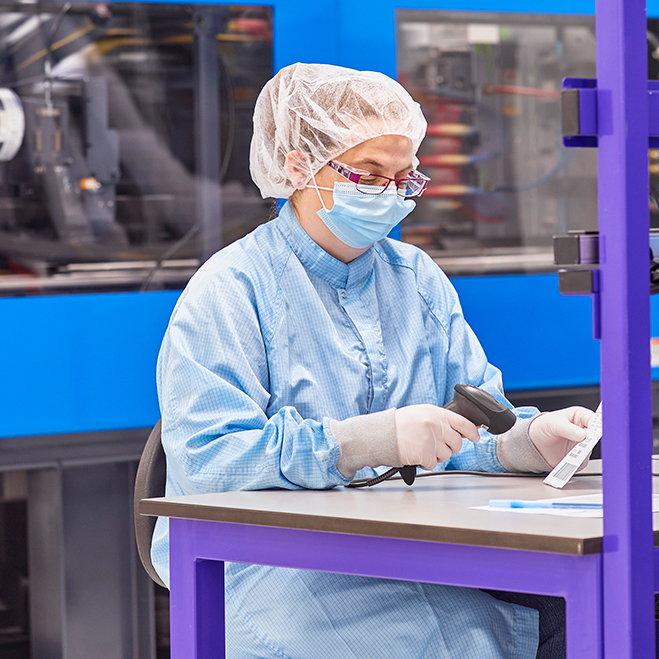 Medical Manufacturing engineer scanning product in a clean room