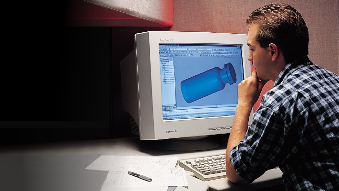 Man looking at old computer monitor with product design