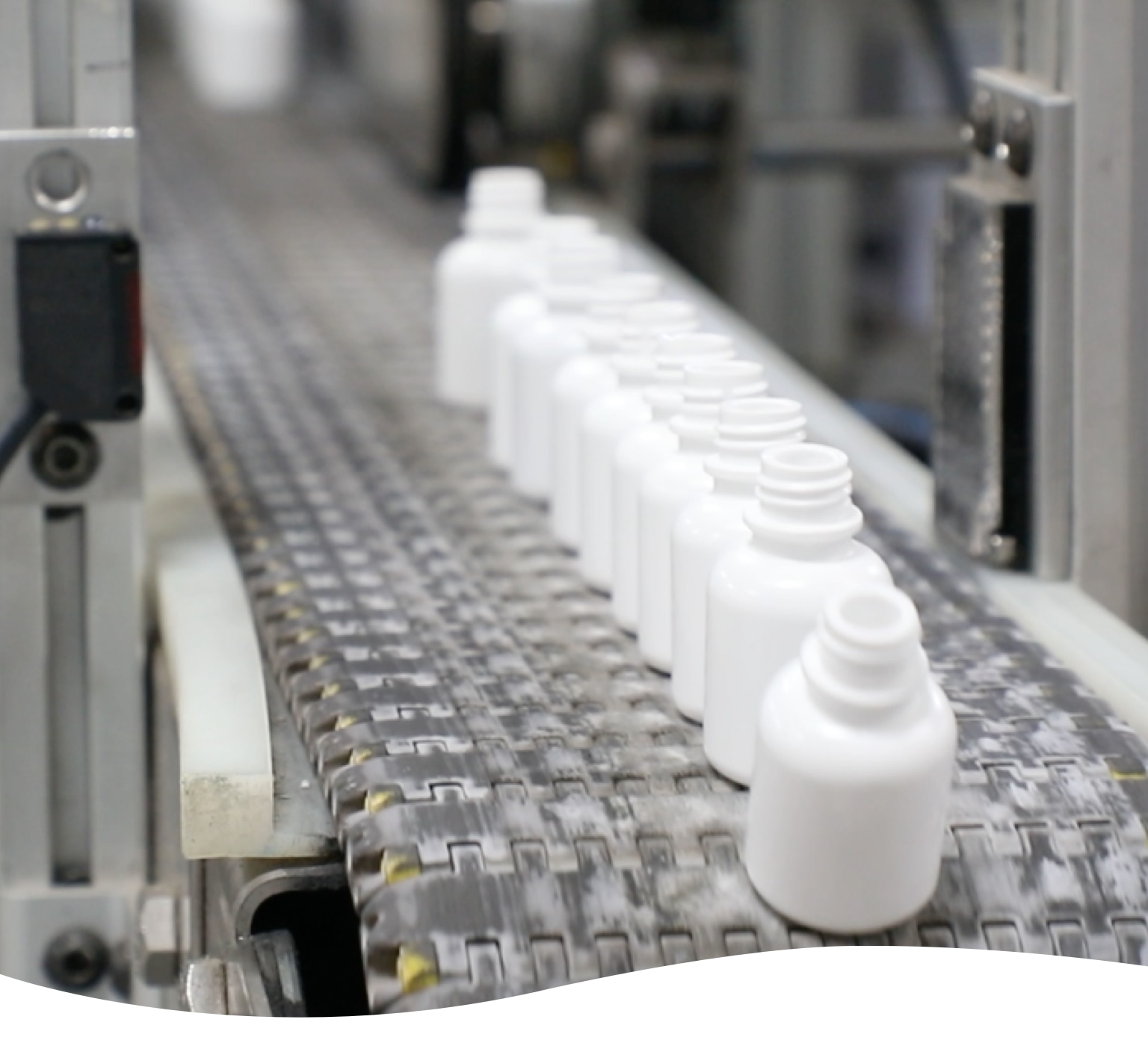 line of plastic manufactured bottles coming off assembly line